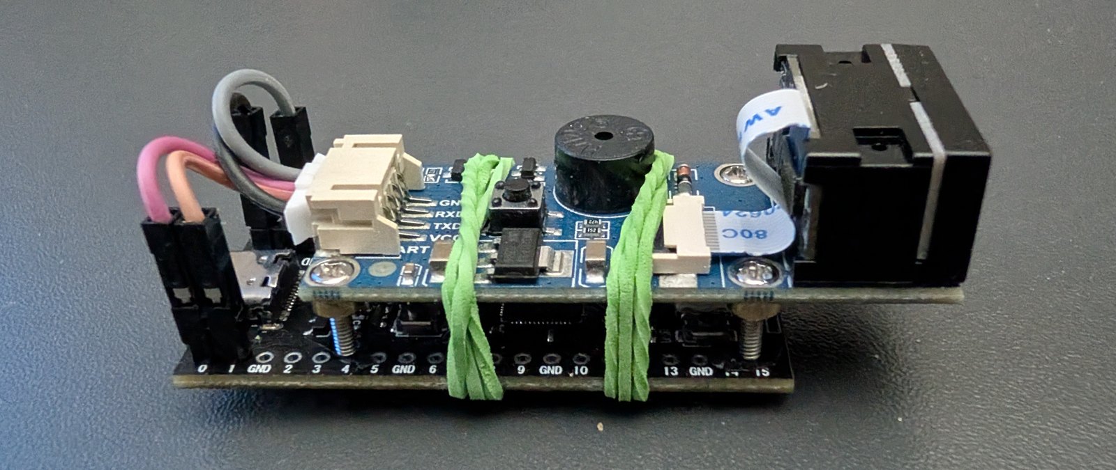 The assembled scanner: an RP2040 board with a 1D/2D scanner module on top